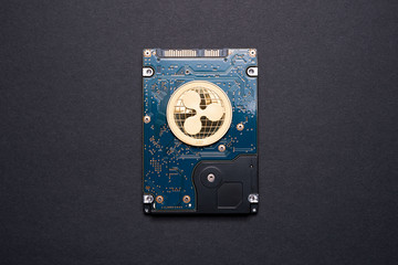 Gold ripple coin on a hard disk drive.