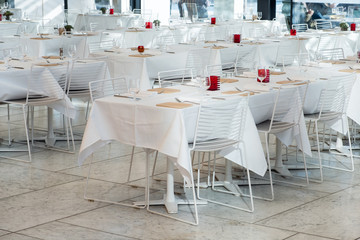 Dining tables with tablecloth and wine glass,napkin,fork in restaurant