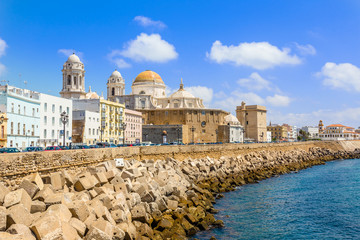 Seafront view of Cadiz with cathedral and street in the background, Cadiz, Spain