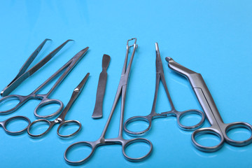 Close Up Surgical instruments and tools on blue mirror background. Selective focus.