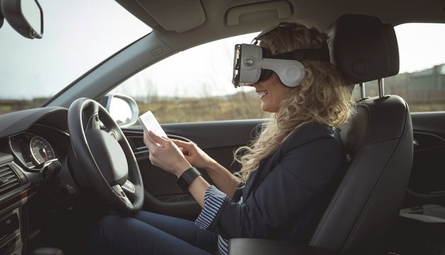 Female executive using digital tablet and virtual reality