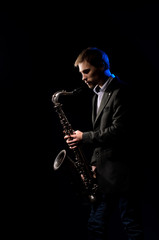 Obraz na płótnie Canvas Saxophonist, illuminated by blue and white light