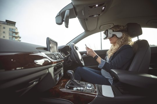 Female executive using digital tablet and virtual reality
