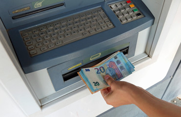 withdrawal of European banknotes from an automatic ATM machine