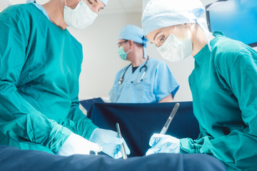 Surgical doctor in full concentration on operation working diligently 