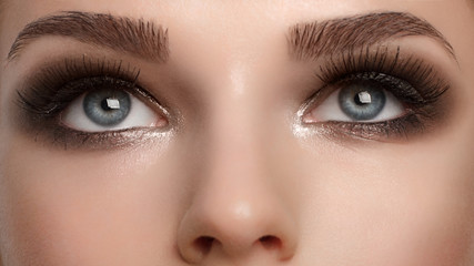 Closeup female eyes with bright make-up, great shapes brows, extreme long eyelashes. Celebrate...