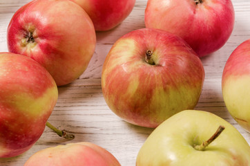 Ripe apples on a wooden table. Apples close-up. Top view.