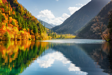 Scenic view of the Panda Lake. Autumn forest reflected in water