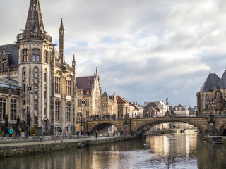 Fototapeta na wymiar Gent - Medieval cathedral and bridge over a canal in Ghent, Belgium. December, 2017