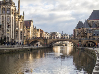Gent - Medieval cathedral and bridge over a canal in Ghent, Belgium. December, 2017