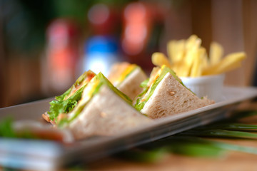 homemade slice ham cheese egg sandwich breakfast with fresh vegetable cucumber on wooden table