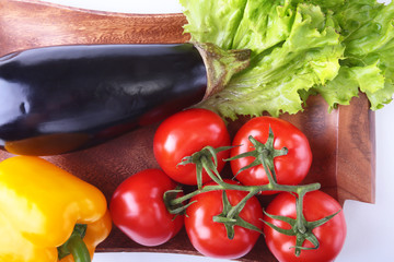 Fresh assorted vegetables, eggplant, bell pepper, tomato, garlic with leaf lettuce. Isolated on white background. Selective focus.