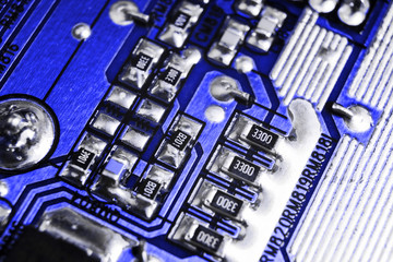 Macro shot of a Circuitboard with resistors microchips and electronic components. Computer hardware technology. Integrated communication processor. Information engineering. Semiconductor. PCB. Closeup