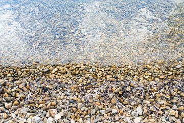 A view of sea and stones in the beautiful beach in the island of Patmos, Greece in summer time