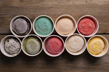 Top view of Ice cream flavors in cup and topping, sweet and dessert food concept
