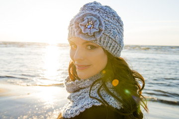 Autumn portrait of the woman in a knitted hat and a handmade scarf