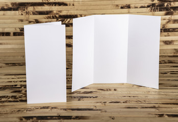 Mockup of white booklet on bamboo background.