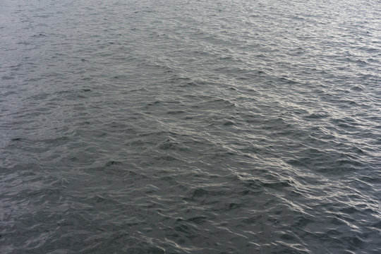 background - lake water with waves on a cloudy day