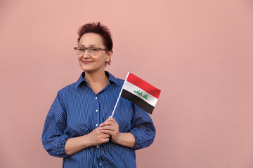 Iraq flag. Woman holding Iraqi flag.