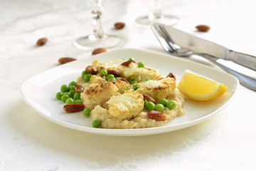 Salad with roasted cauliflower and green peas, almonds served on vegetable puree