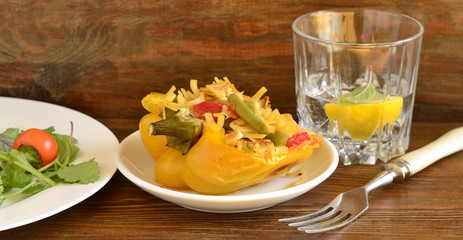 Yellow bell pepper stuffed with vegetables and noodles