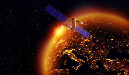 satellite with a golden sunrise of the sun above the earth
