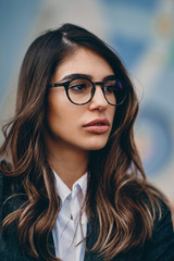 Head shot of beautiful brunette wearing glasses.