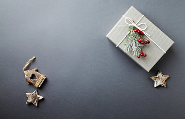 A Gift Box and Christmas Decorations on gray background. Symbolic image. Flatlay. Copy space