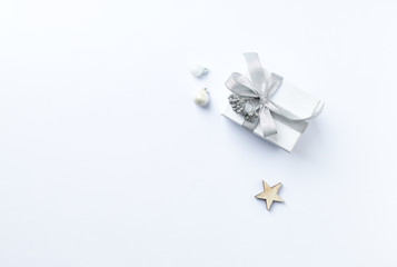A Gift Box and Christmas Decorations on white background. Symbolic image. Flatlay. Copy space