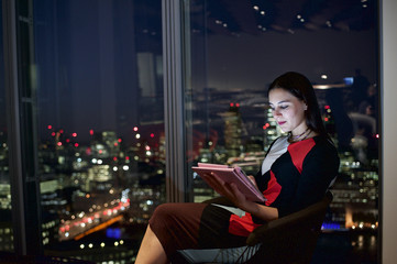 Executive woman in a corporate office working late