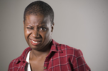 Obraz premium lifestyle portrait if young unhappy and pretty african American woman in contempt and disgust face expression as if disliking or finding disgusting