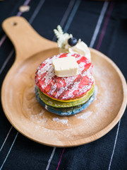 Fresh baked Rainbow Pancake with icing sugar and butter