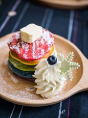 Fresh baked Rainbow Pancake with icing sugar and butter