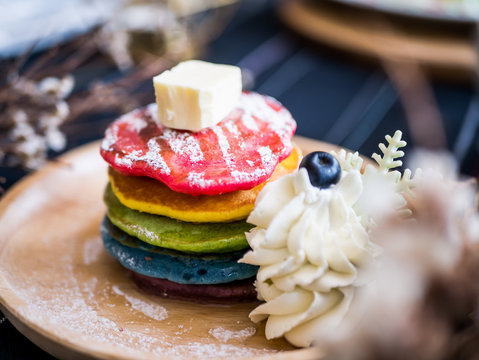 Fresh baked Rainbow Pancake with icing sugar and butter