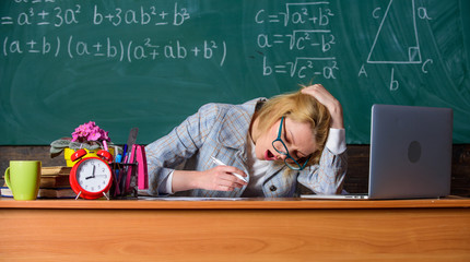 Still working. Work far beyond actual school day. Teacher tired face keep working after classes....