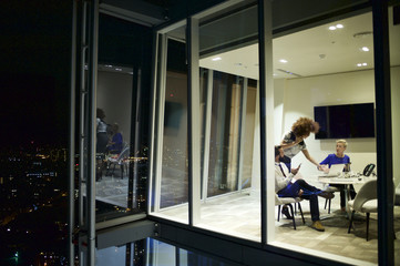 Executives in a corporate office working late