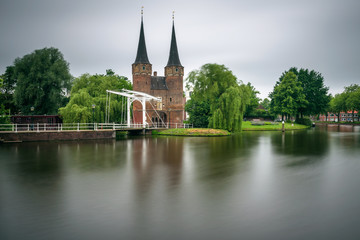 Fototapeta na wymiar Eastern gate, canal and historic drawbridge in Delft, Netherland