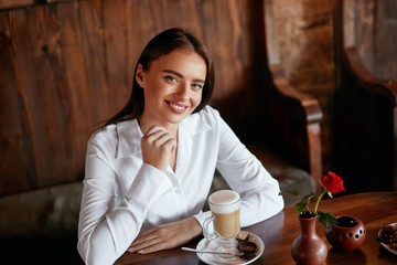 Woman Drinking Coffee In Cafe