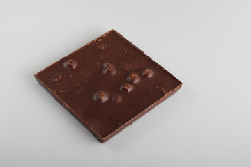 chocolate bar with hazelnut on a light background