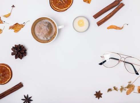 Cofffee, candle and dry spices and leaves on white background.