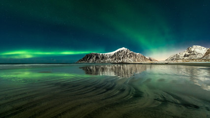 Norway - Lofoten island -  Skagsanden beach lines with large Aurora