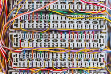 Complex massy managed colorful telephone cable lines in analog PBX box
