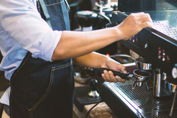 Barista men are making coffee to serve customers.