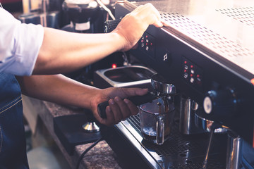 Barista men are making coffee to serve customers.