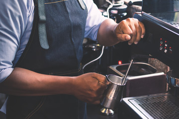 Barista men are milking bubbles for coffee.