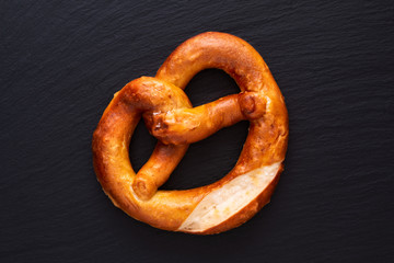 Homemade twisted knot Soft salt Pretzels on black slate board background