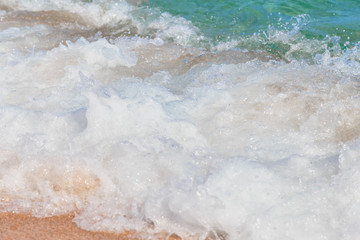 Fototapeta na wymiar Sea wave, running on the sandy shore
