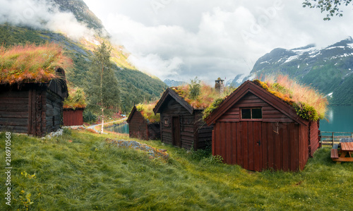 Traditional Scandinavian Old Wooden Houses With Grass Roofs Near