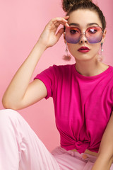 Beautiful brunette in studio on a pink background