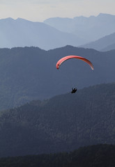 Paraglider in front of alpine mountain range